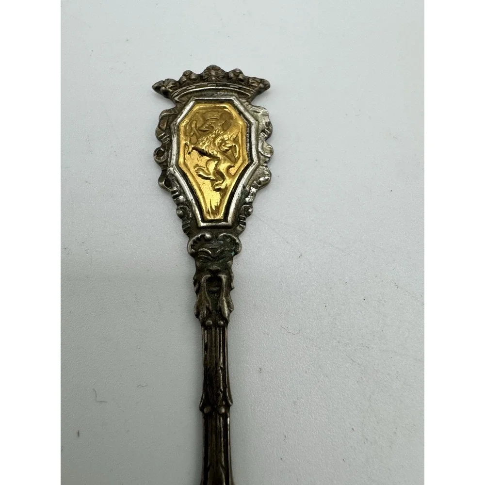 Ornate Italian souvenir fork with a lion rampant and crown motif